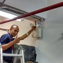 Técnico instalando luz de emergencia